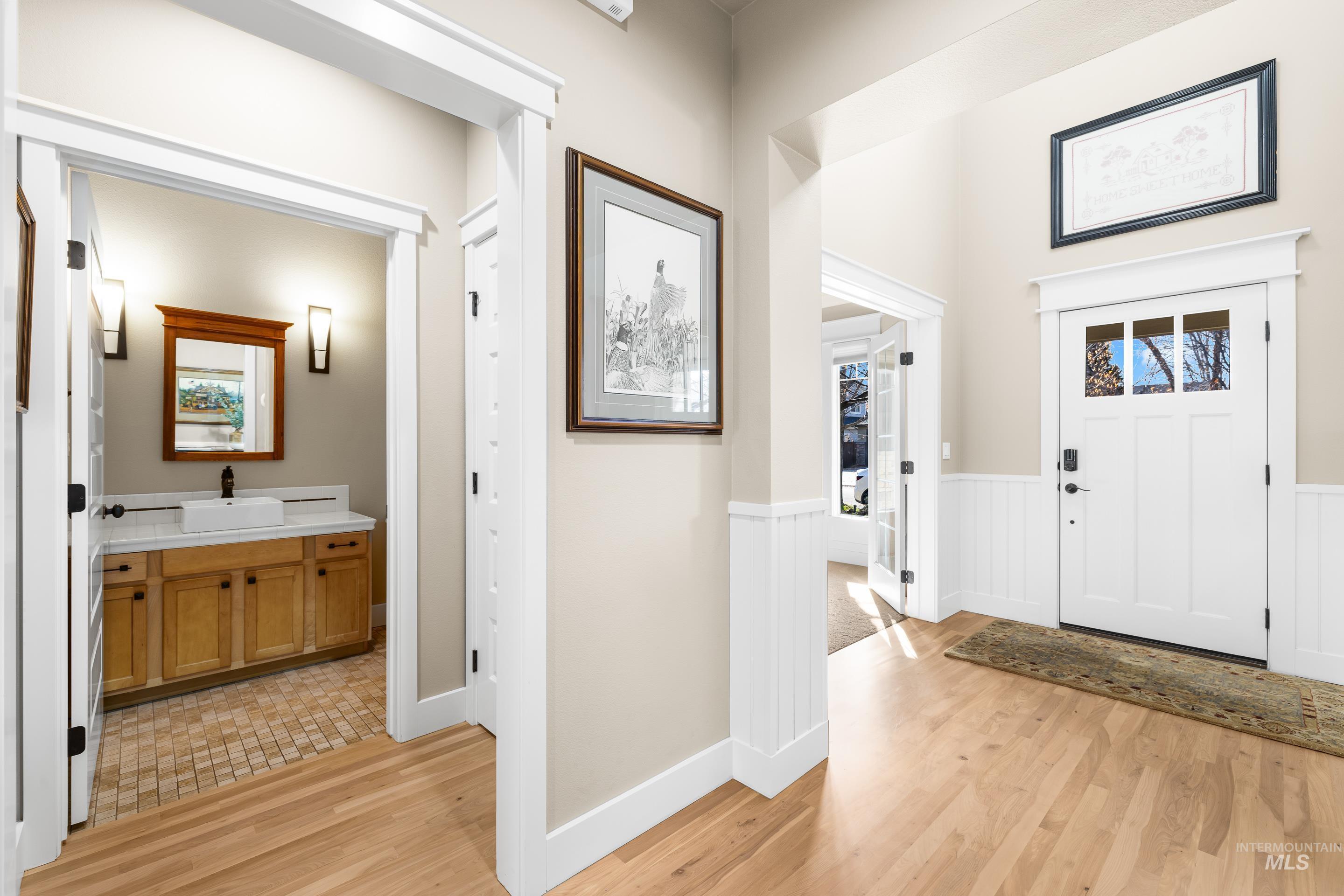 836 West Colbert Street Meridian, ID 83646 - Photo 9 of 45 Entrance foyer featuring light wood finished floors and a wainscoted wall