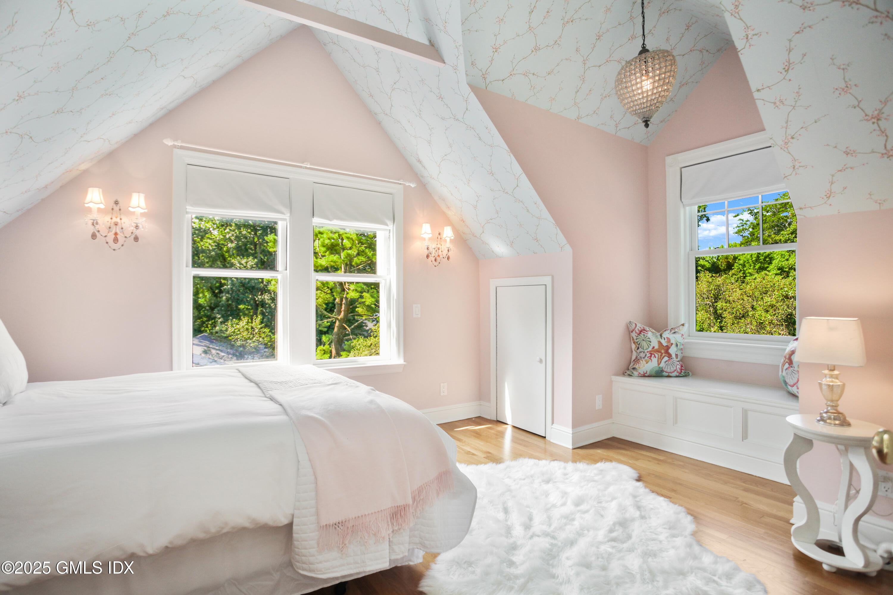 29 Weston Hill Road Riverside, CT 06878 - Photo 20 of 23 a spacious bedroom with a bed and a chandelier