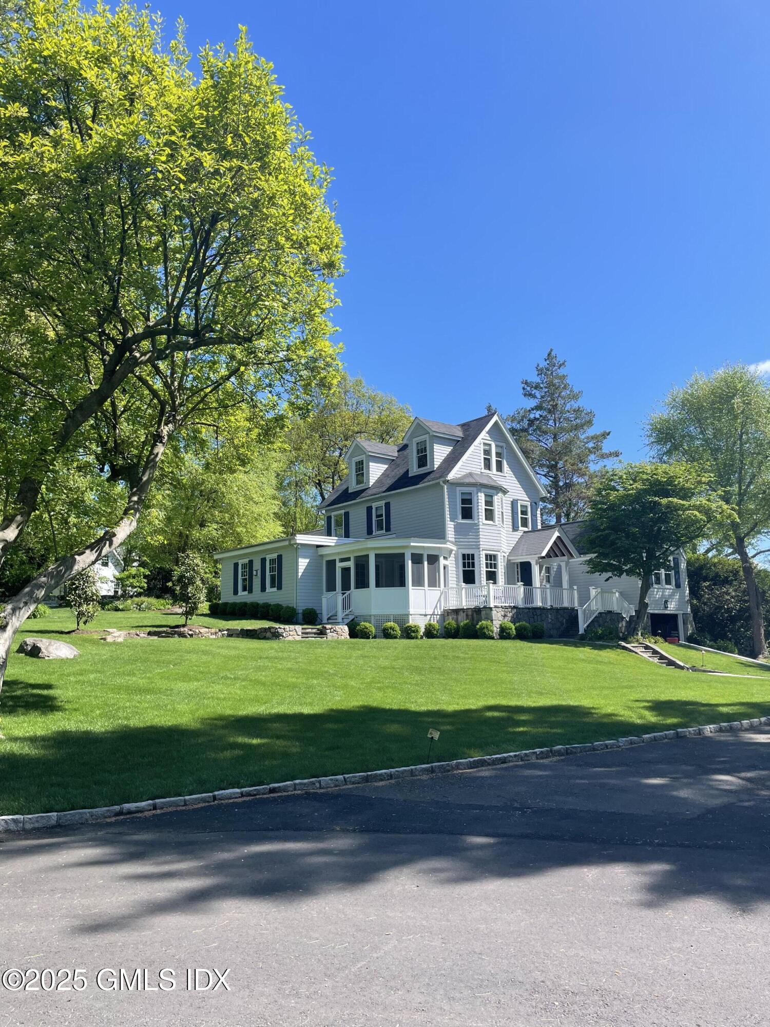 29 Weston Hill Road Riverside, CT 06878 - Photo 2 of 23 a front view of a house with a yard and garage