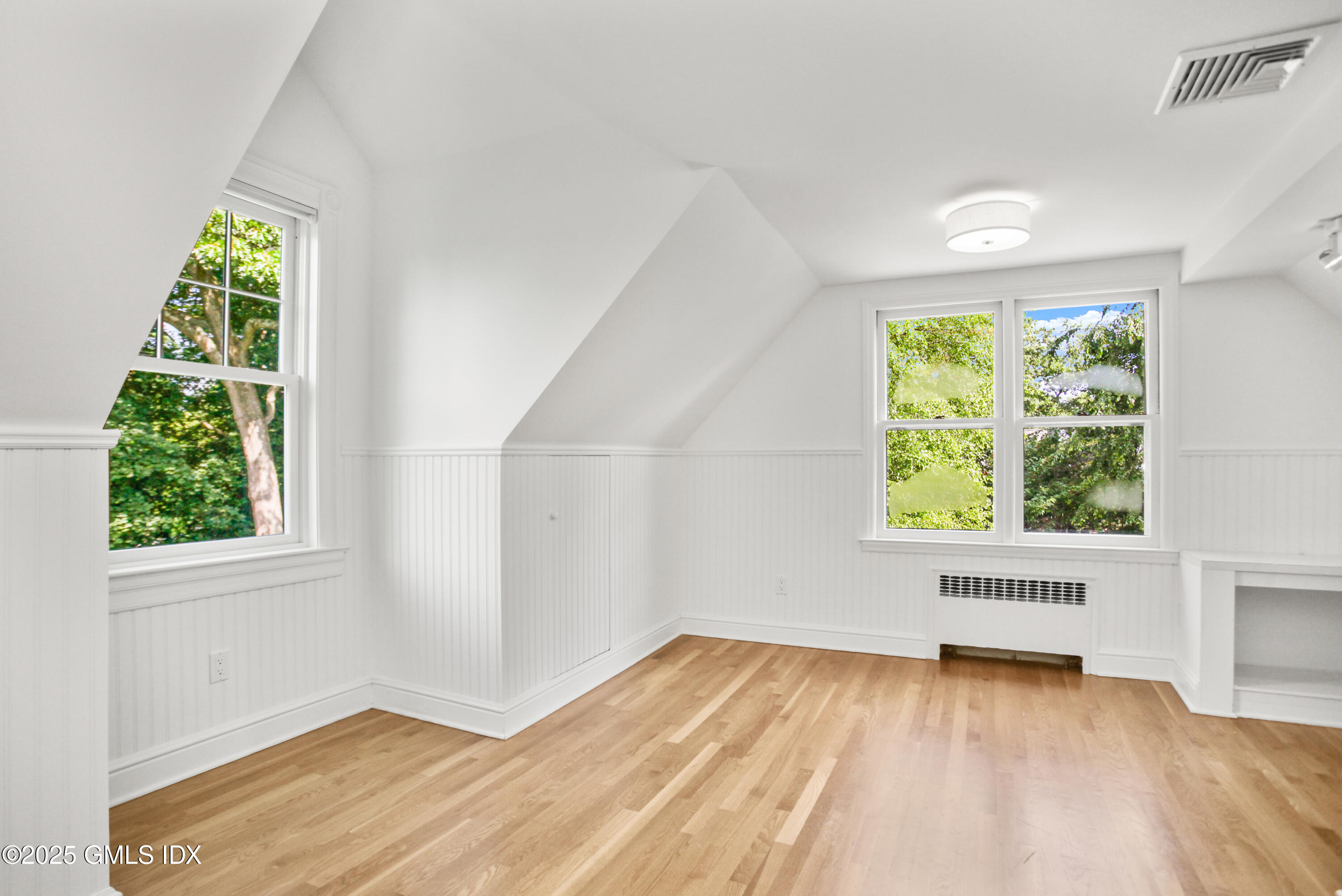 29 Weston Hill Road Riverside, CT 06878 - Photo 21 of 23 an empty room with wooden floor and windows