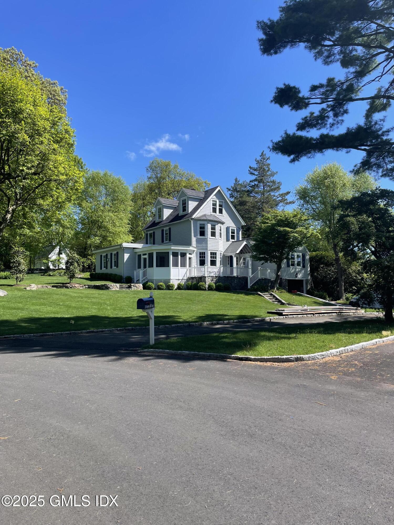 29 Weston Hill Road Riverside, CT 06878 - Photo 22 of 23 a view of a house with a big yard and potted plants