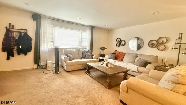 a view of a livingroom with furniture and windows
