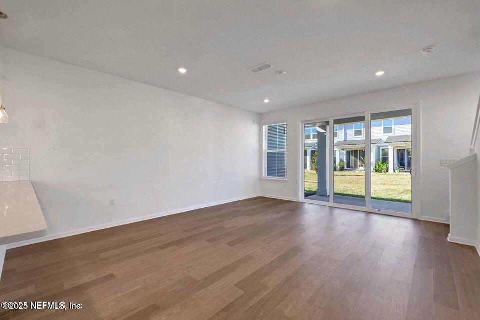 36 Thurnham Lane St. Augustine, FL 32092 - Photo 3 of 15 a view of an empty room with wooden floor and a window