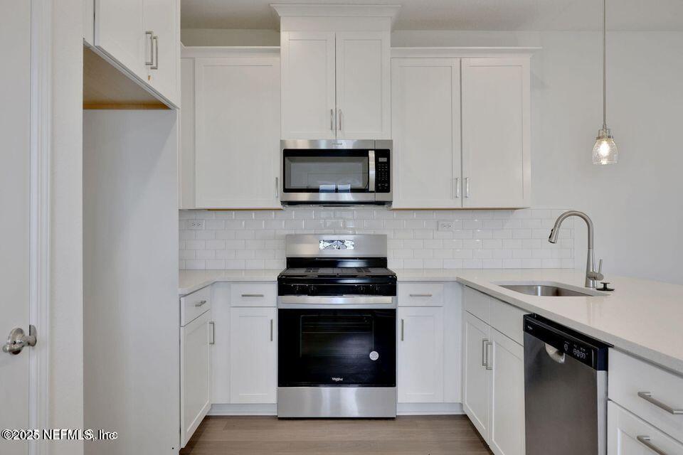 36 Thurnham Lane St. Augustine, FL 32092 - Photo 5 of 15 a kitchen with stainless steel appliances a stove and a microwave