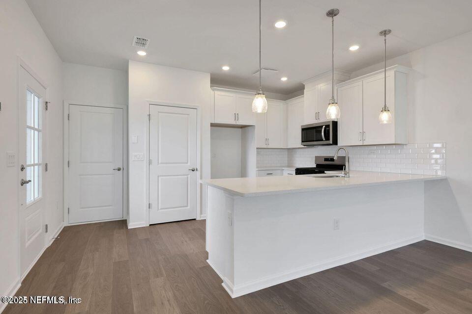 36 Thurnham Lane St. Augustine, FL 32092 - Photo 6 of 15 a open kitchen with white cabinets and stainless steel appliances