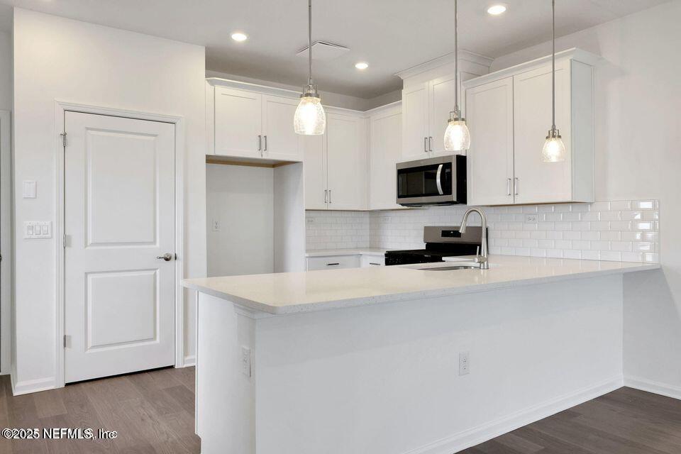 36 Thurnham Lane St. Augustine, FL 32092 - Photo 7 of 15 a kitchen with stainless steel appliances a refrigerator a sink and a stove