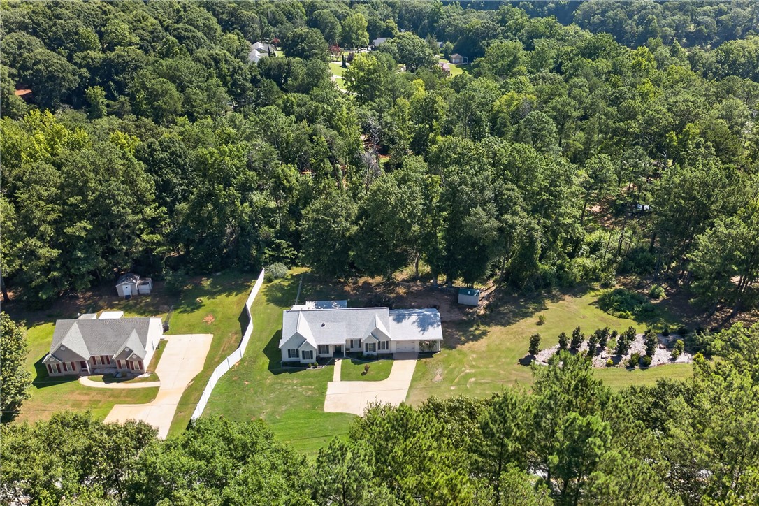 3336 Centerville Road Anderson, SC 29625 - Photo 43 of 50 An aerial perspective reveals two homes nestled within a verdant, tree-lined landscape.