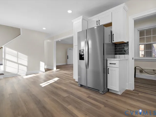 a kitchen with stainless steel appliances a refrigerator and a stove top oven