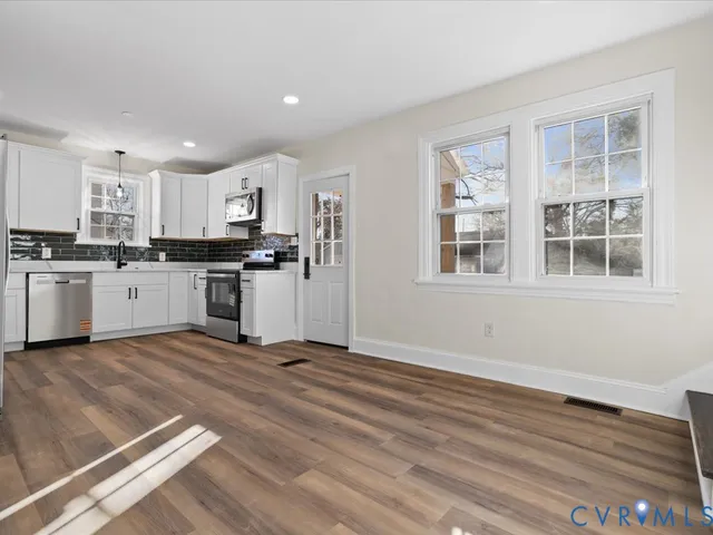 a view of a kitchen with a stove top oven