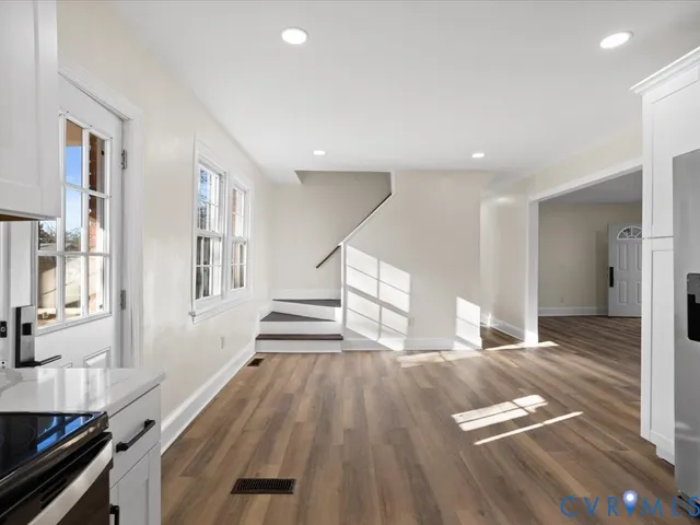 a view of a living room with wooden floor