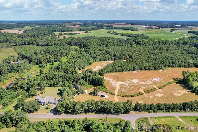 an aerial view of residential houses with outdoor space and river
