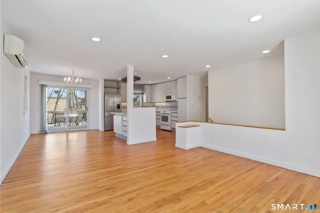 a kitchen with stainless steel appliances a white stove top oven and cabinets