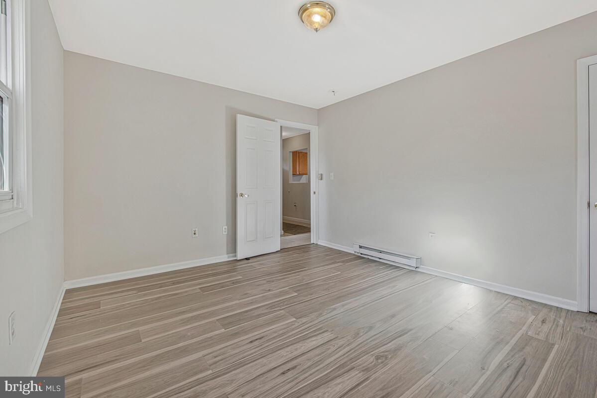 7712 Frederick Road Hyattsville, MD 20784 - Photo 14 of 30 a view of an empty room with wooden floor