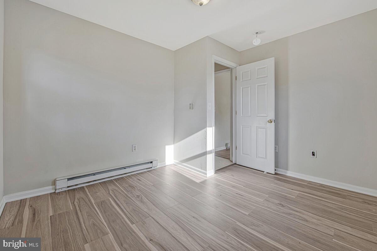 7712 Frederick Road Hyattsville, MD 20784 - Photo 15 of 30 a view of an empty room with wooden floor