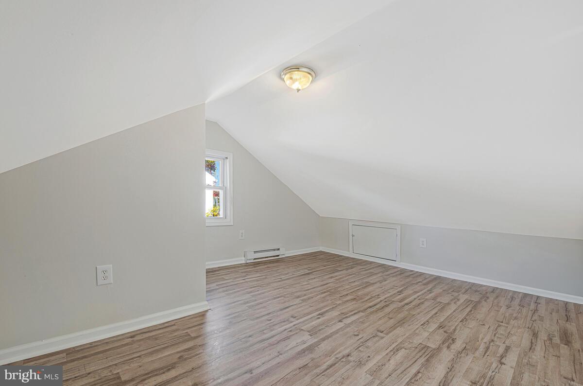 7712 Frederick Road Hyattsville, MD 20784 - Photo 19 of 30 a view of empty room with wooden floor