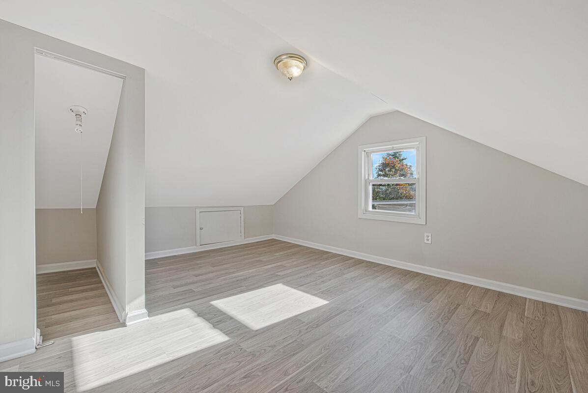 7712 Frederick Road Hyattsville, MD 20784 - Photo 21 of 30 an empty room with wooden floor and windows