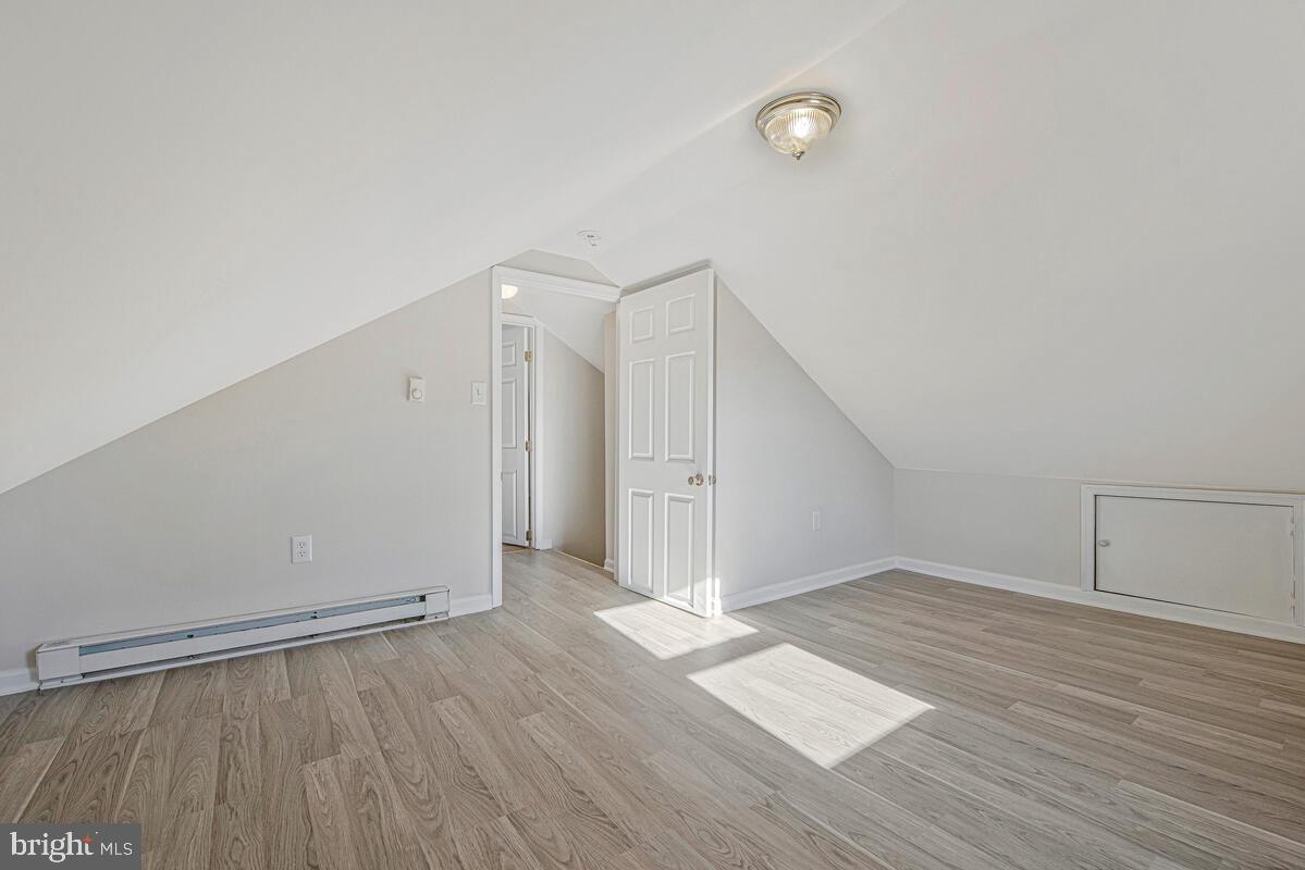 7712 Frederick Road Hyattsville, MD 20784 - Photo 22 of 30 a view of an empty room with wooden floor