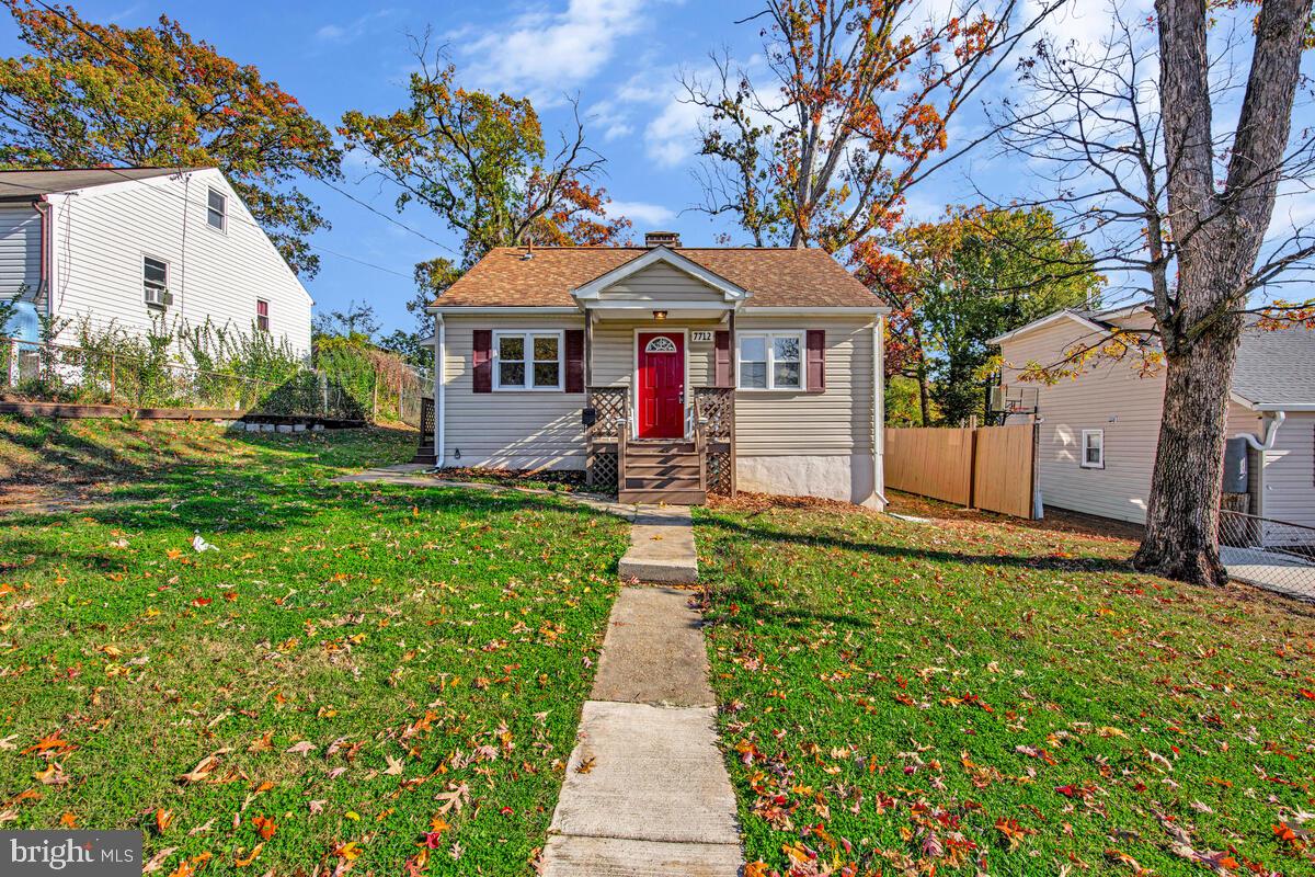 7712 Frederick Road Hyattsville, MD 20784 - Photo 4 of 30 a front view of a house with a yard
