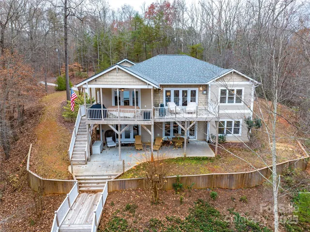 an aerial view of a house with swimming pool and porch
