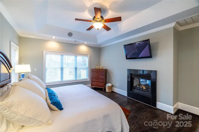 a living room with a large mirror and a clock on the table