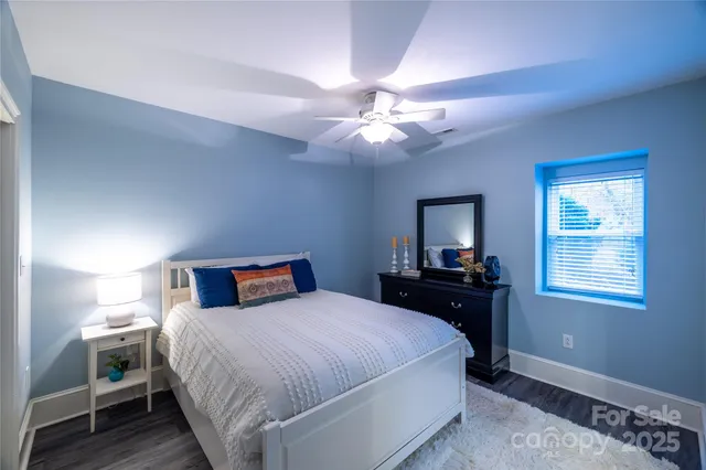 a bedroom with a large bed and a chandelier