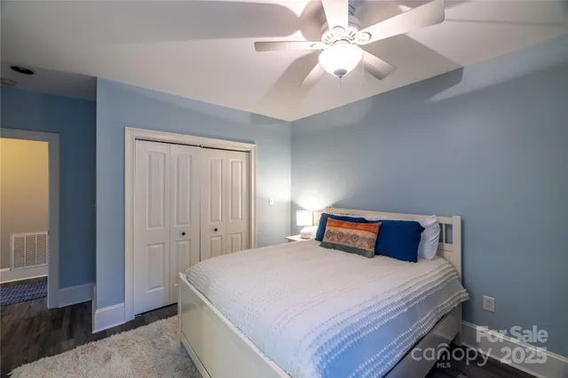 a en suite bathroom with a granite countertop sink and a mirror