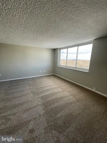 an empty room with a empty space and windows