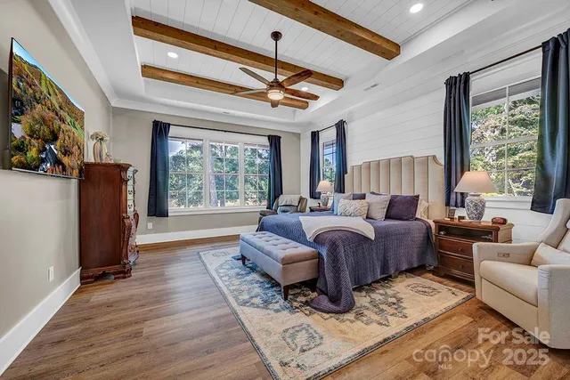 a spacious bedroom with a bed a couch and a window