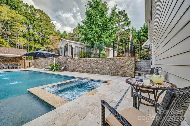 a bathroom with a granite countertop sink a toilet and shower