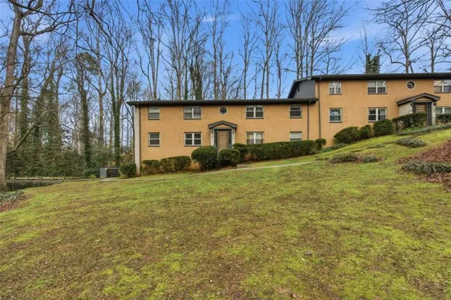 a view of a house with backyard and garden