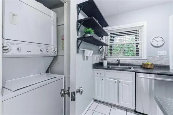 a kitchen with a sink a refrigerator and window