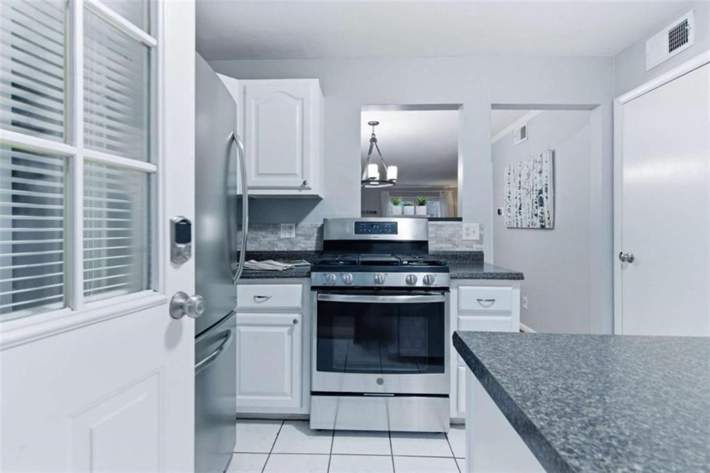1010 Scott Boulevard, Unit B1 Decatur, GA 30030 - Photo 4 of 20 a kitchen with stainless steel appliances granite countertop a stove a sink and a refrigerator