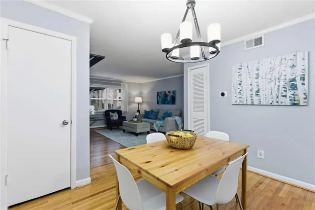 a view of a dining room with furniture wooden floor and chandelier