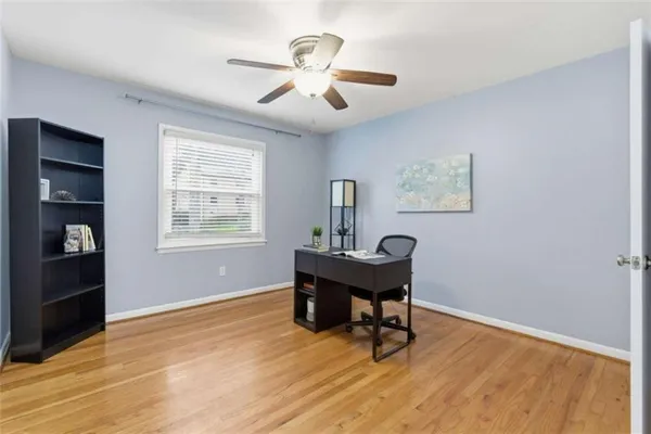 a workspace with wooden floor and a window