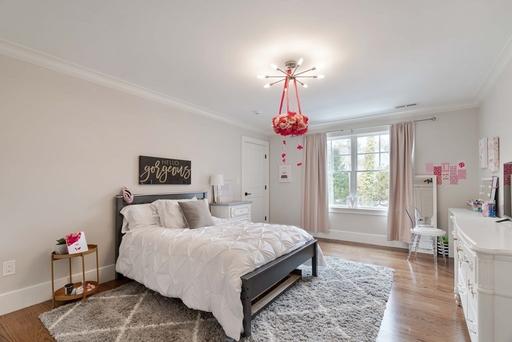 700 Chestnut Street Needham, MA 02492 - Photo 16 of 41 a bedroom with a bed chandelier and a window