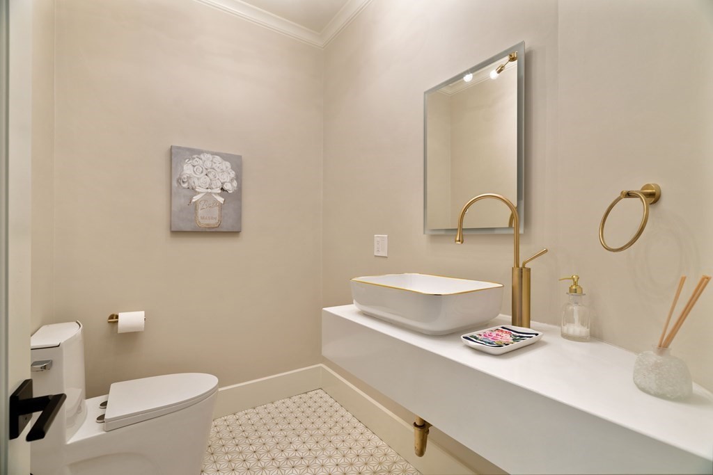 700 Chestnut Street Needham, MA 02492 - Photo 24 of 41 a bathroom with a toilet a sink and mirror