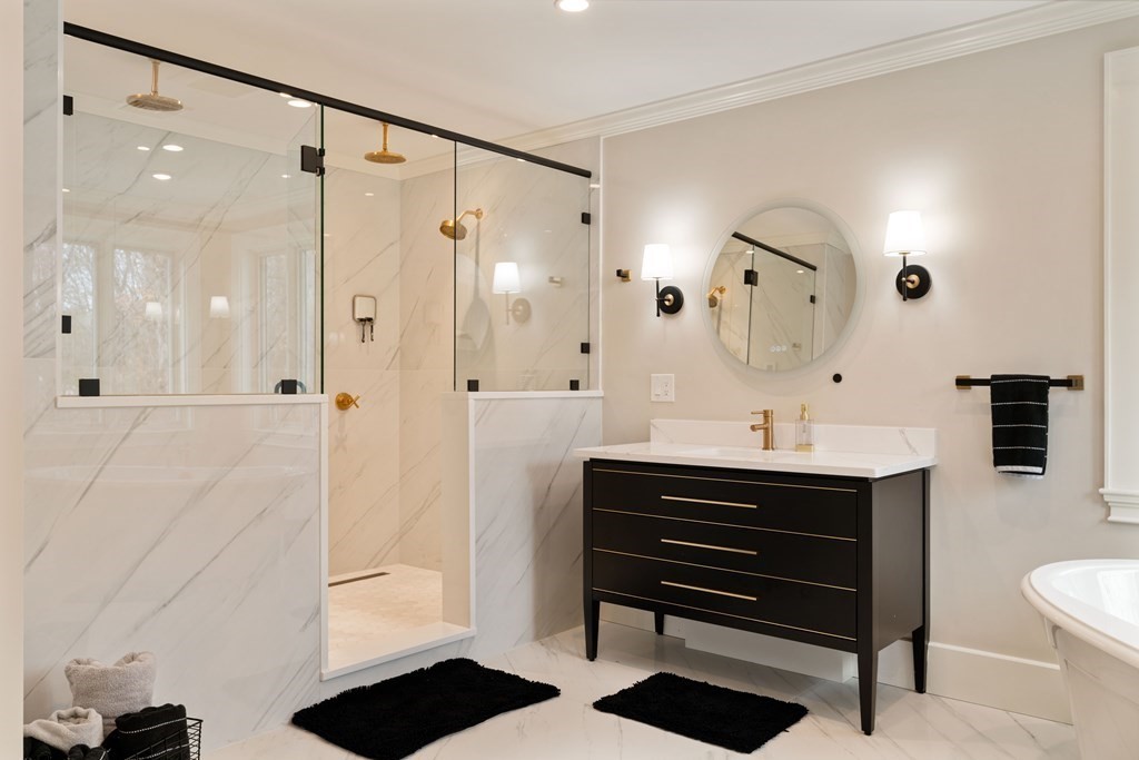 700 Chestnut Street Needham, MA 02492 - Photo 29 of 41 a bathroom with a double vanity sink a toilet a mirror and shower