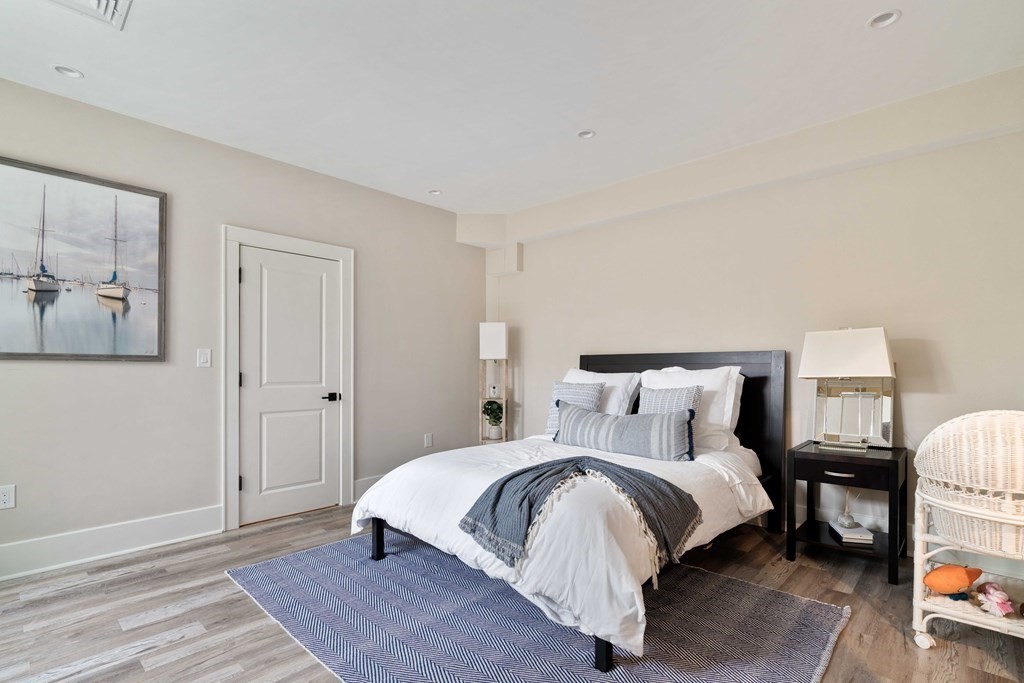 700 Chestnut Street Needham, MA 02492 - Photo 36 of 41 a bed room with a bed and a lamp