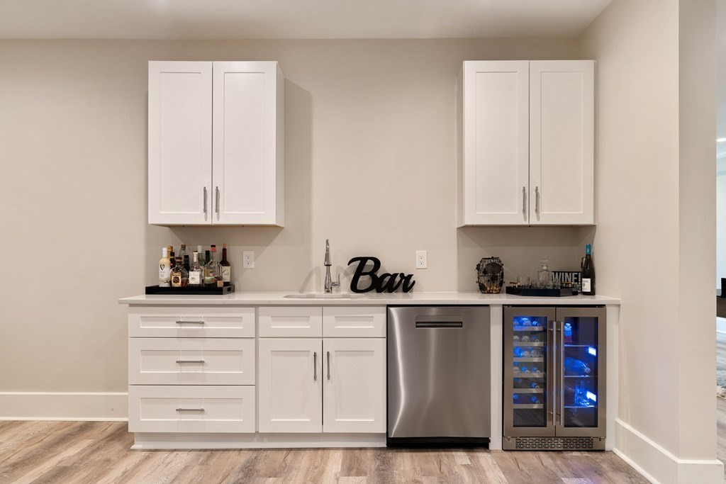 700 Chestnut Street Needham, MA 02492 - Photo 37 of 41 a kitchen with stainless steel appliances granite countertop a stove a sink and white cabinets