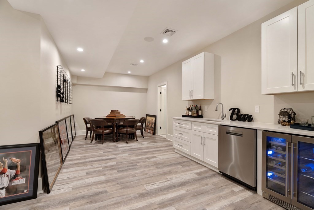 700 Chestnut Street Needham, MA 02492 - Photo 38 of 41 a large white kitchen with stainless steel appliances granite countertop a stove and a sink with cabinets