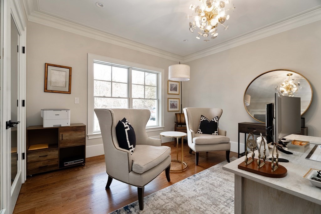 700 Chestnut Street Needham, MA 02492 - Photo 41 of 41 a living room with furniture a fireplace and a chandelier