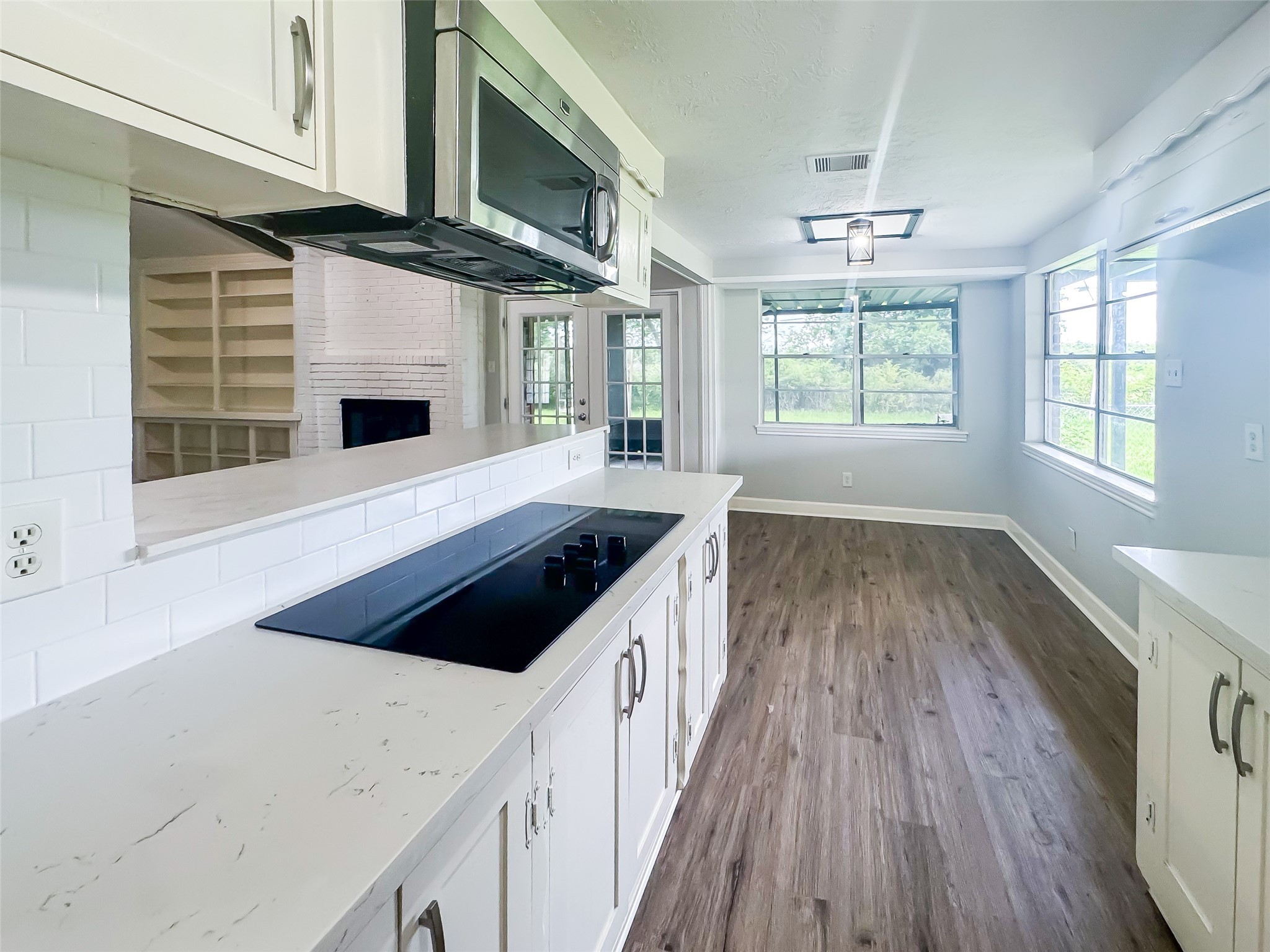 912 Robinson Road La Porte, TX 77571 - Photo 11 of 39 a kitchen with stainless steel appliances kitchen island granite countertop a stove a sink and a microwave