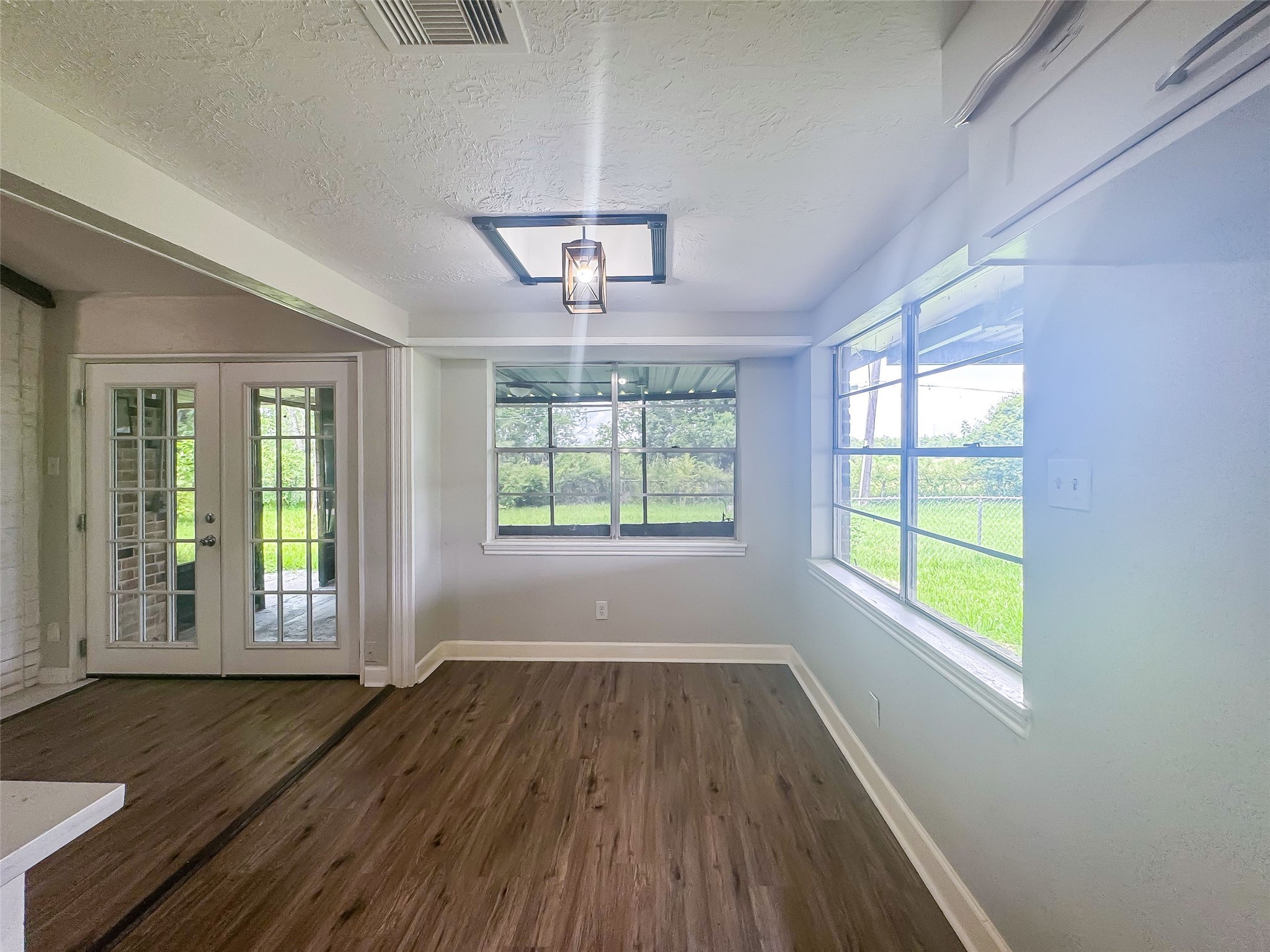 912 Robinson Road La Porte, TX 77571 - Photo 12 of 39 a view of an empty room with wooden floor and a window