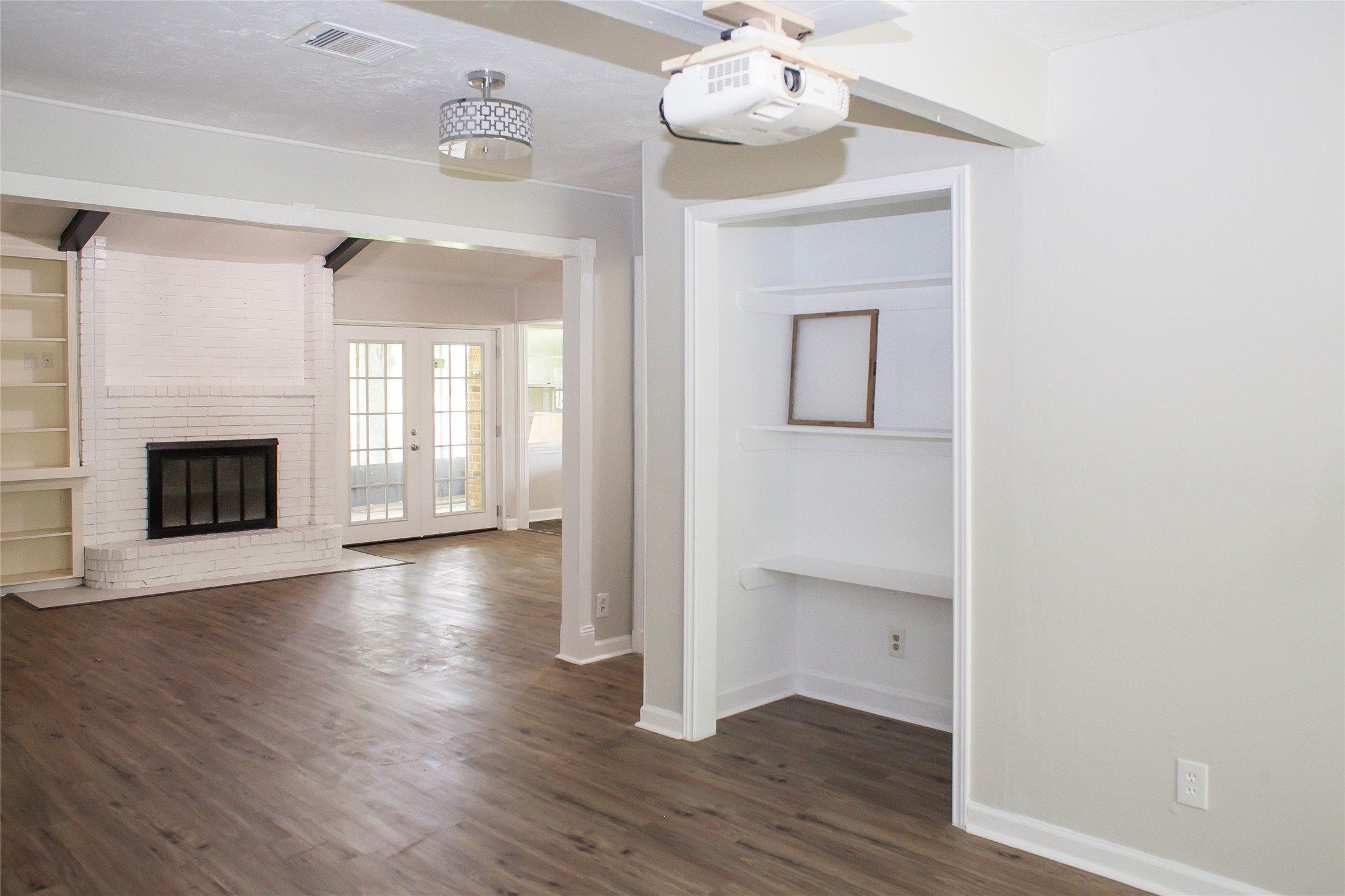 912 Robinson Road La Porte, TX 77571 - Photo 27 of 39 an empty room with wooden floor fireplace and windows