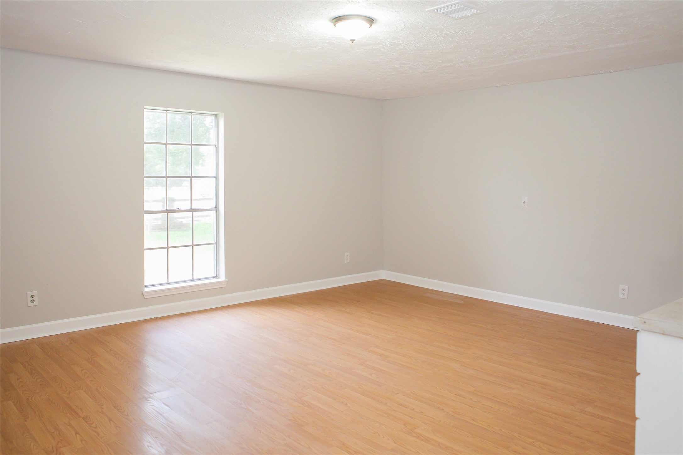 912 Robinson Road La Porte, TX 77571 - Photo 7 of 39 wooden floor in an empty room with a window