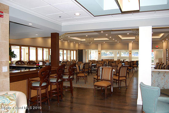 1432 Patriot Drive Melbourne, FL 32940 - Photo 7 of 17 a room with lots of wooden furniture and large windows