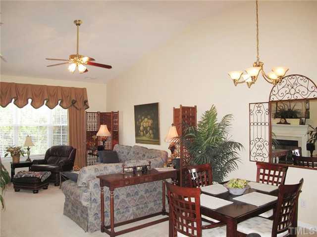 10472 Dapping Drive Raleigh, NC 27614 - Photo 4 of 12 a living room with furniture a chandelier and a window