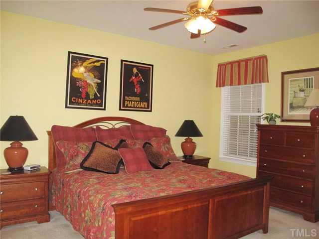 10472 Dapping Drive Raleigh, NC 27614 - Photo 7 of 12 a bedroom with a bed and a painting on the wall