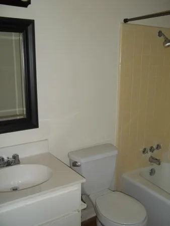 a bathroom with a toilet sink and shower