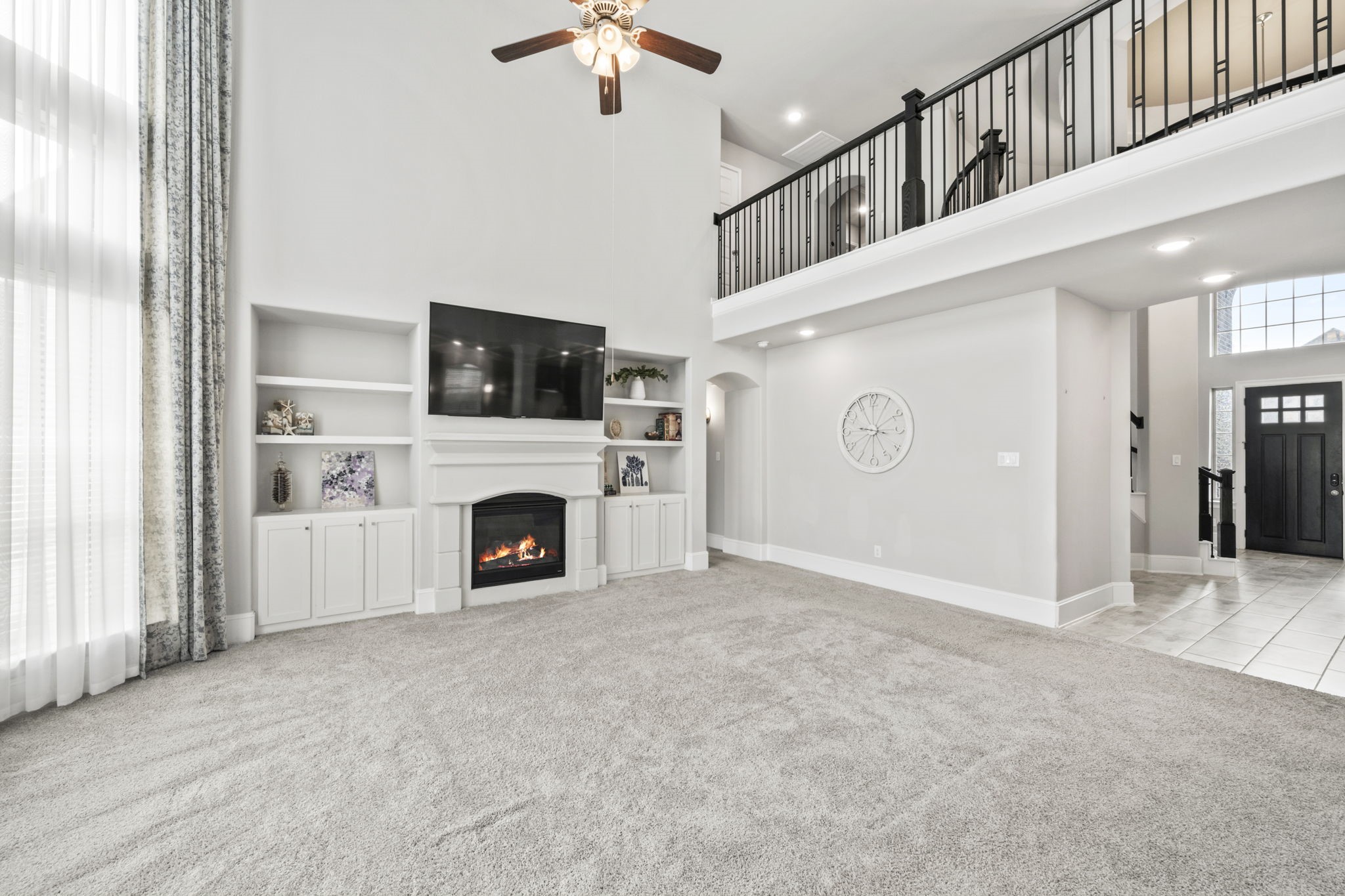 3938 Avalon Ridge Drive Spring, TX 77386 - Photo 17 of 49 The fireplace is cozy and the catwalk upstairs has wrought iron rails for a beautiful updated look